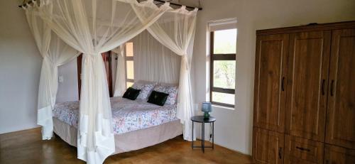 Ένα ή περισσότερα κρεβάτια σε δωμάτιο στο Phumula Bushvilla