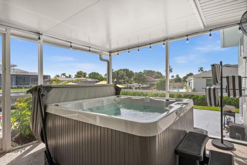 a hot tub on the patio of a house at Casa Azul - Waterfront Villa with Pool & Dock in Marco Island