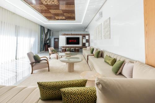 a living room with a couch and a table at Villa Ramona, Calme, Luxe et Piscine in Marrakesh
