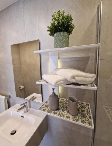 a bathroom with a sink and a toilet and a mirror at 8 North Lodge By Petit Chic in Mellieħa