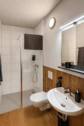 a bathroom with a toilet and a sink and a shower at la Plaza24 in Düsseldorf