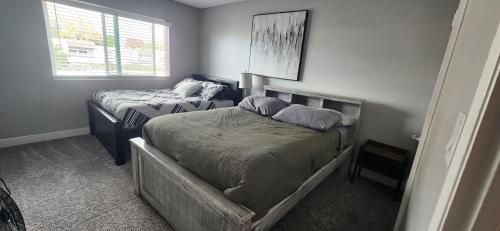 a bedroom with two twin beds and a window at Cozy 2bdr Beach home in Huntington Beach