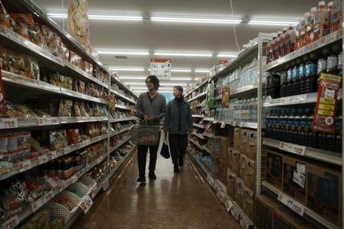 two people walking through a grocery store aisle at Kamifu INN in Kami-furano