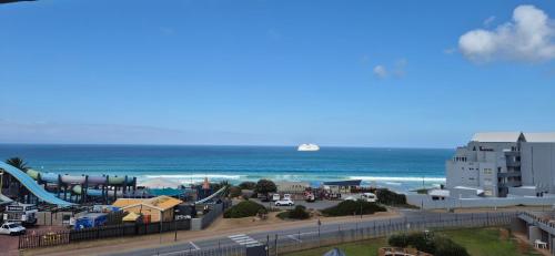 a view of a beach with a cruise ship in the ocean at 59 De Valle, Diaz Beach in Mossel Bay
