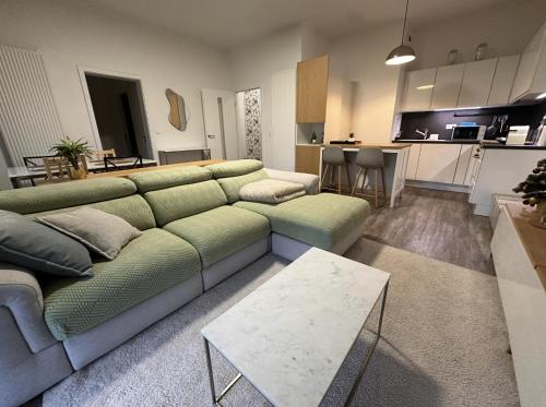 un salon avec un canapé et une cuisine dans l'établissement Le beau Strasbourg, à Strasbourg