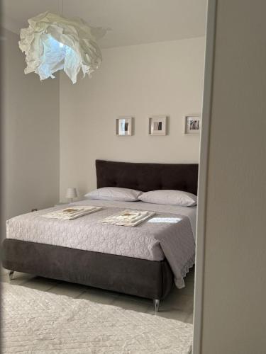 a bedroom with a large bed with a white wall at Moravita B&B in San Tammaro