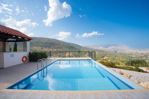 a swimming pool with a view of a mountain at Villa Petra- Panormic Sea view - Private Pool in Kalyves