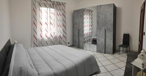 Ένα ή περισσότερα κρεβάτια σε δωμάτιο στο Il Ciclamino, a due passi dalla Reggia e dallo Stadio