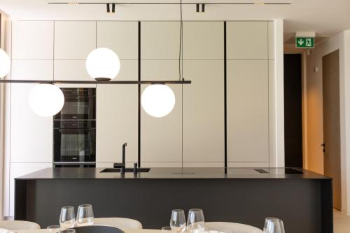 a dining room with white walls and tables and lights at LIOQA Resort in Ugljan