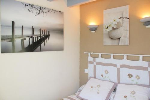 a bedroom with a bed and two pictures on the wall at La Roche Bleue in Saint-Bois