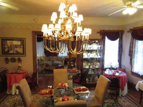 a living room with a chandelier and a dining room at Peace & Plenty Inn Bed and Breakfast Downtown St Augustine-Adults Only in Saint Augustine
