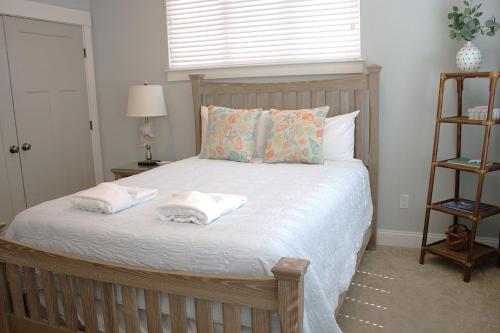 a bedroom with a bed with two towels on it at 410A The Jetty House in Virginia Beach