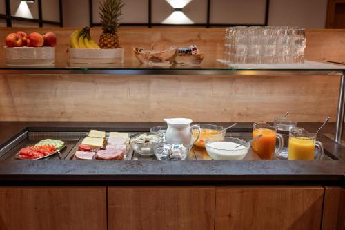 a buffet with food and drinks on a counter at Hotel & Gasthof Taferne in Schladming