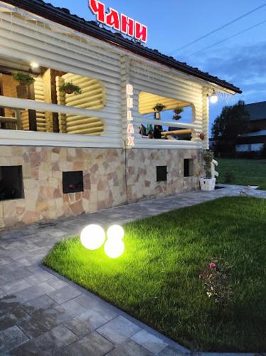 a house with lights on the grass in front of it at Садиба "Hutsulyana" in Yablunytsya