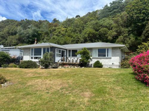 a home with a hill in the background at Close To Beach, Sunny, Getaway - KK16786 in Kaikoura
