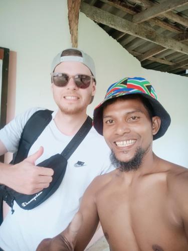 two men are posing for a picture together at navaa Bungalow in Phra Ae beach