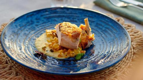 a blue plate with a piece of food on it at Sal Salis Ningaloo Reef in Exmouth