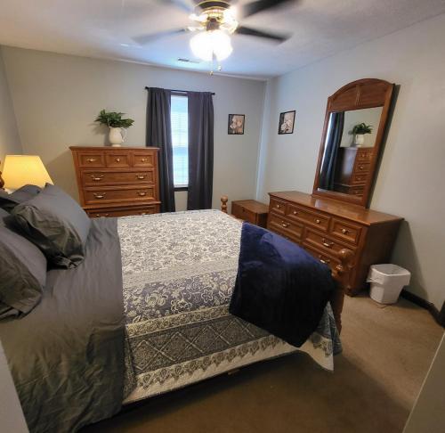 a bedroom with a bed and a dresser and a mirror at Wildwood Estates in Lynchburg