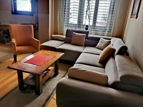 a living room with a couch and a table at Planinski Mir in Zaovine