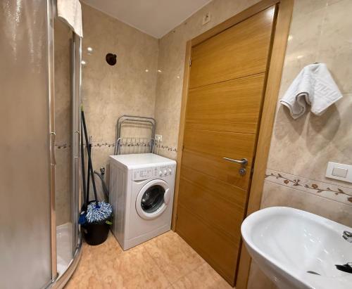 a bathroom with a washing machine and a sink at SP 64 Vut in Lugo