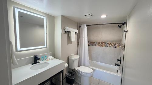 a bathroom with a sink and a toilet and a shower at Border Plaza Hotel in San Diego