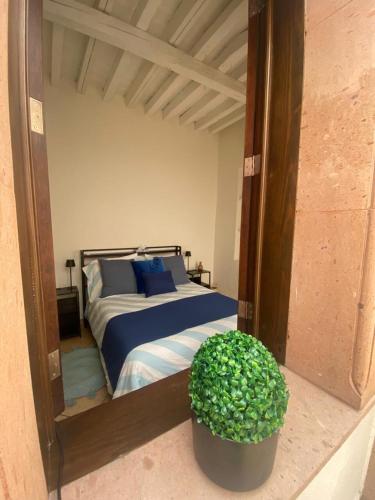 a bedroom with a bed with a large mirror at Casabel - Downtown Querétaro in Querétaro