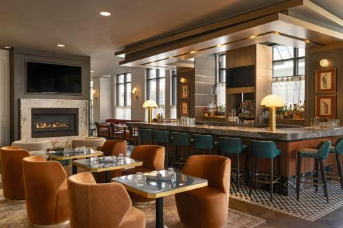 a restaurant with a bar and a fireplace at Hotel Ivy, a Luxury Collection Hotel, Minneapolis in Minneapolis
