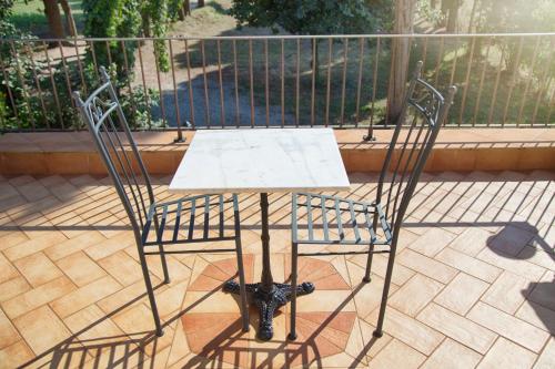 a table and two chairs on a patio at Don Carlo Agriturismo di Charme Bio in Le Pioppe
