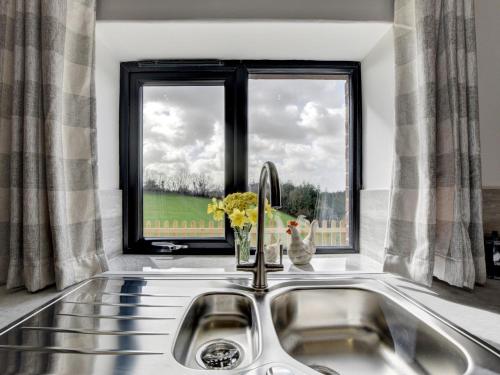 a kitchen sink with a window in a kitchen at 2 Bed in South Molton 88993 in Bishops Nympton