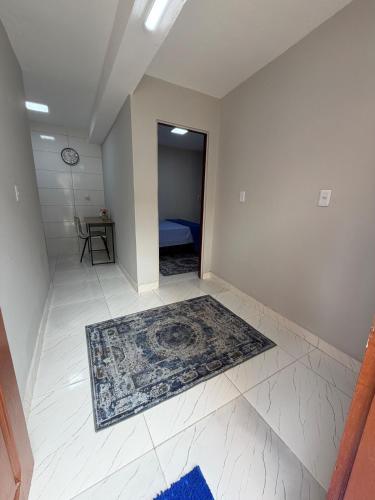 an empty room with a rug on the floor at AmazHost - Casa azul próxima da Basílica de Nazaré in Belém