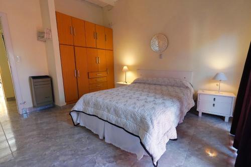 a bedroom with a large bed and two night stands at Los colibríes in Necochea