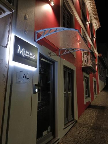 a sign for a restaurant on the side of a building at Memória Charming House in Angra do Heroísmo