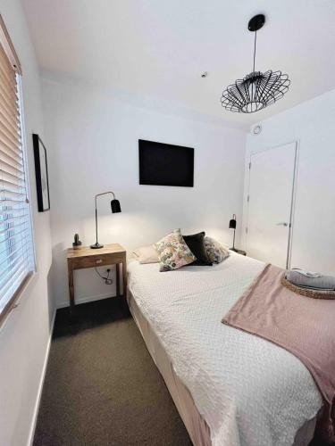a bedroom with a bed and a television on the wall at Room at the heart of the city! in Auckland