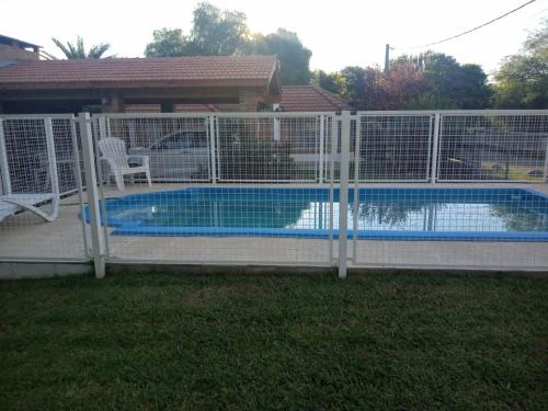 a fence around a swimming pool in a yard at Divina providencia in Merlo