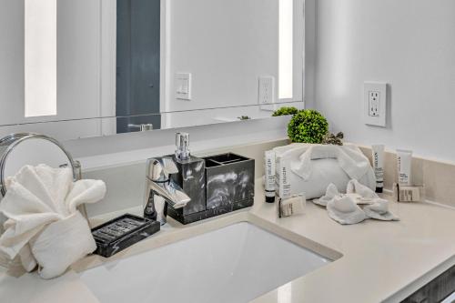 a bathroom counter with a sink with a mirror at Modern Studio City Views in Miami