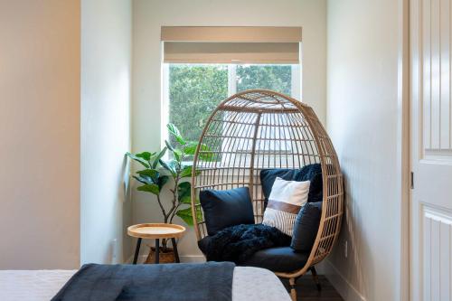 a rattan chair in a room with a window at New modern home - movie and game room - Family Friendly in Post Falls