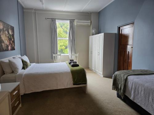 a hotel room with two beds and a window at Royal Accommodation in Stratford