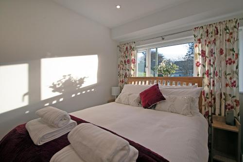 a bedroom with a bed with two towels on it at Cornish Dreams in Camborne