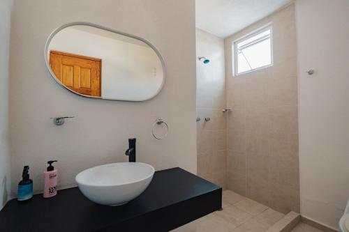 a bathroom with a white bowl sink and a shower at Family House with Pool and Jacuzzi in Morelos in Chiconcuac