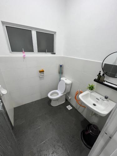 a bathroom with a toilet and a sink at Zh homestay teluk batik in Lumut