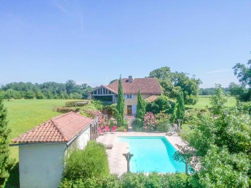 an aerial view of a house with a swimming pool at Beautiful farmhouse with private pool in Le Houga