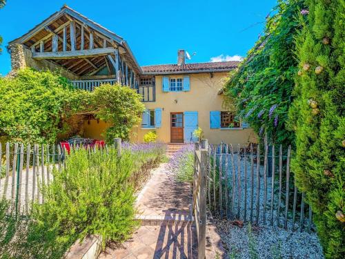 a house with a fence in front of it at Beautiful farmhouse with private pool in Le Houga