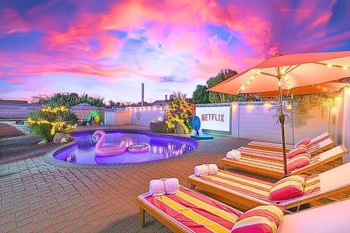 a pool with two lounge chairs and an umbrella at Ella Oasis Heated Pool Hot Tub Near Old Town in Scottsdale