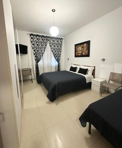 a bedroom with a bed and a window and a couch at Lora's House 5Terre in La Spezia