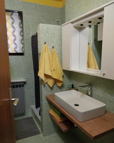 a bathroom with a white sink and a mirror at Apartments with parking space Rabac, Labin - 7438 in Rabac