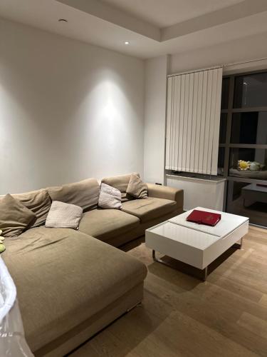 a living room with a couch and a coffee table at En-suite Room LUXURIOUS 2 bed Flatshare in London
