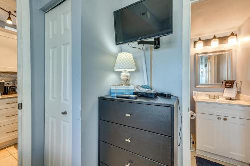 a room with a dresser with a tv on a wall at Ocean-View Penthouse Condo in North Myrtle Beach! in Myrtle Beach
