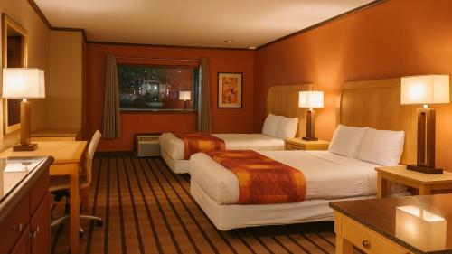 a hotel room with two beds and a desk at Gated 2 Double Beds Studio with Full Kitchen 106 in Baton Rouge