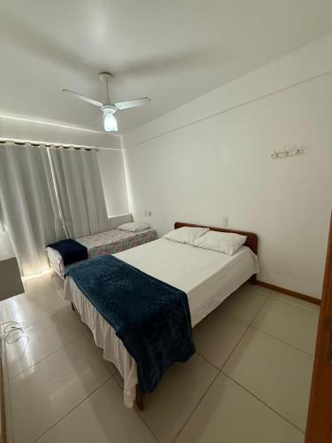 a bedroom with two beds and a ceiling fan at Apartamento com vista da Baía do Pontal in Ilhéus