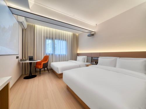 En eller flere senge i et værelse på The Screen Hotel Hangzhou East St ation-Zhanongkou Metro